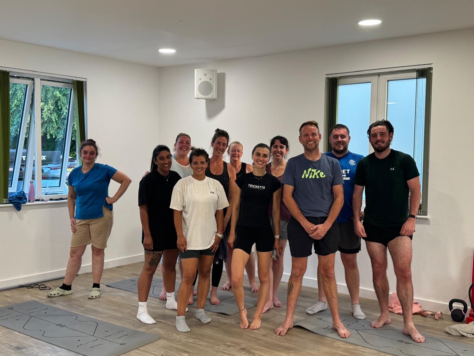 A large group of Tricketts kettlebell training clients smiling together