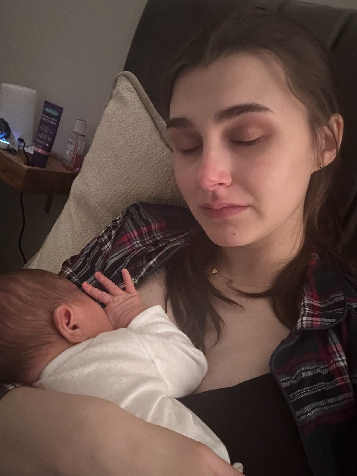 Jess in the early days of motherhood, holding her newborn